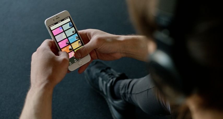 Student With Headphones Holding a Smartphone